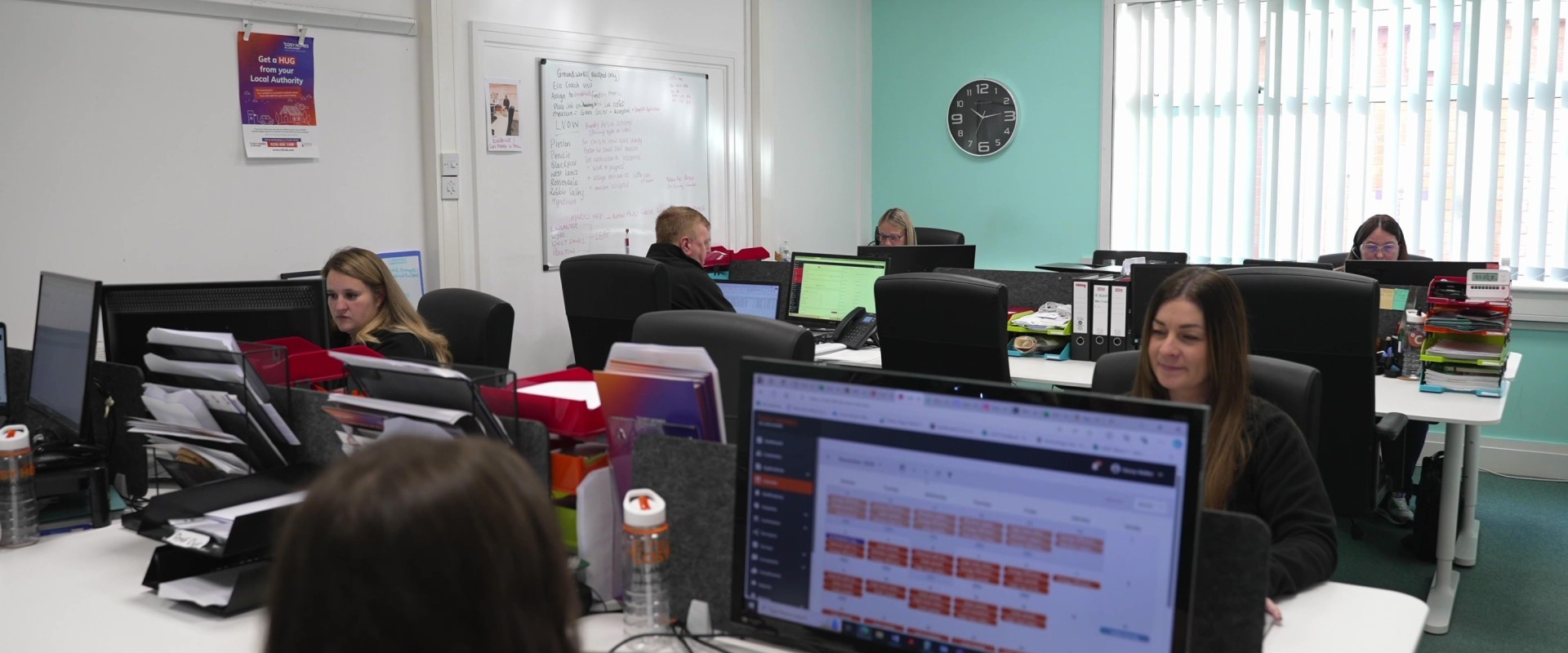 Staff working at desks in the Cosy Homes in Lancashire office