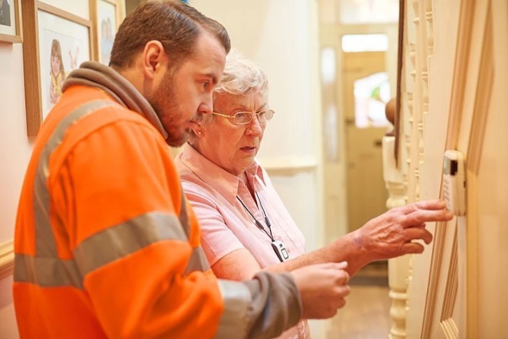 Heating Engineer with an old lady in her home